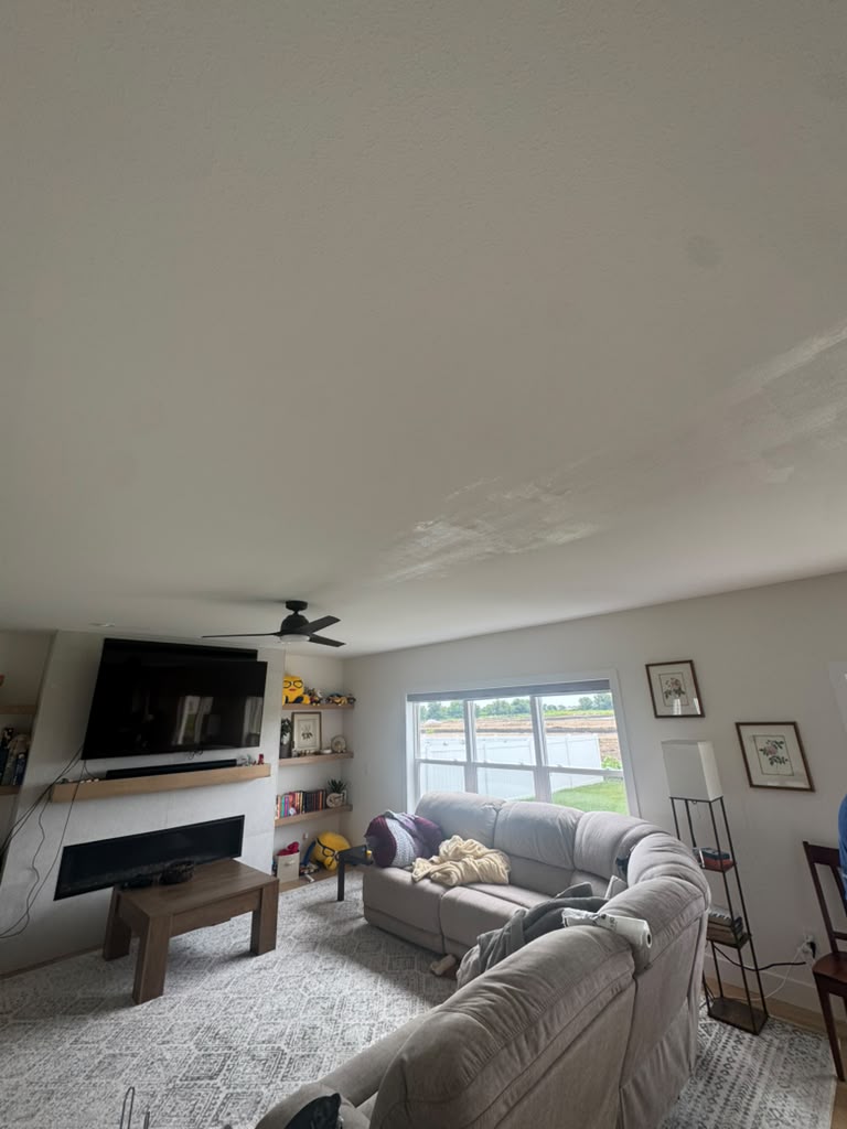 Living room ceiling with water damage before drywall repair