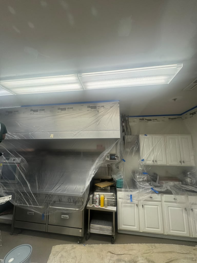 Commercial kitchen equipment wrapped for painting