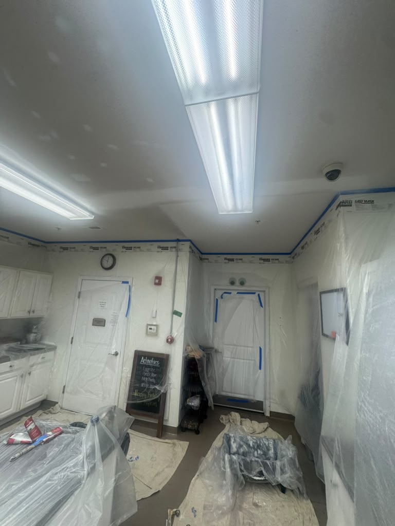 Commercial kitchen cabinets taped for painting