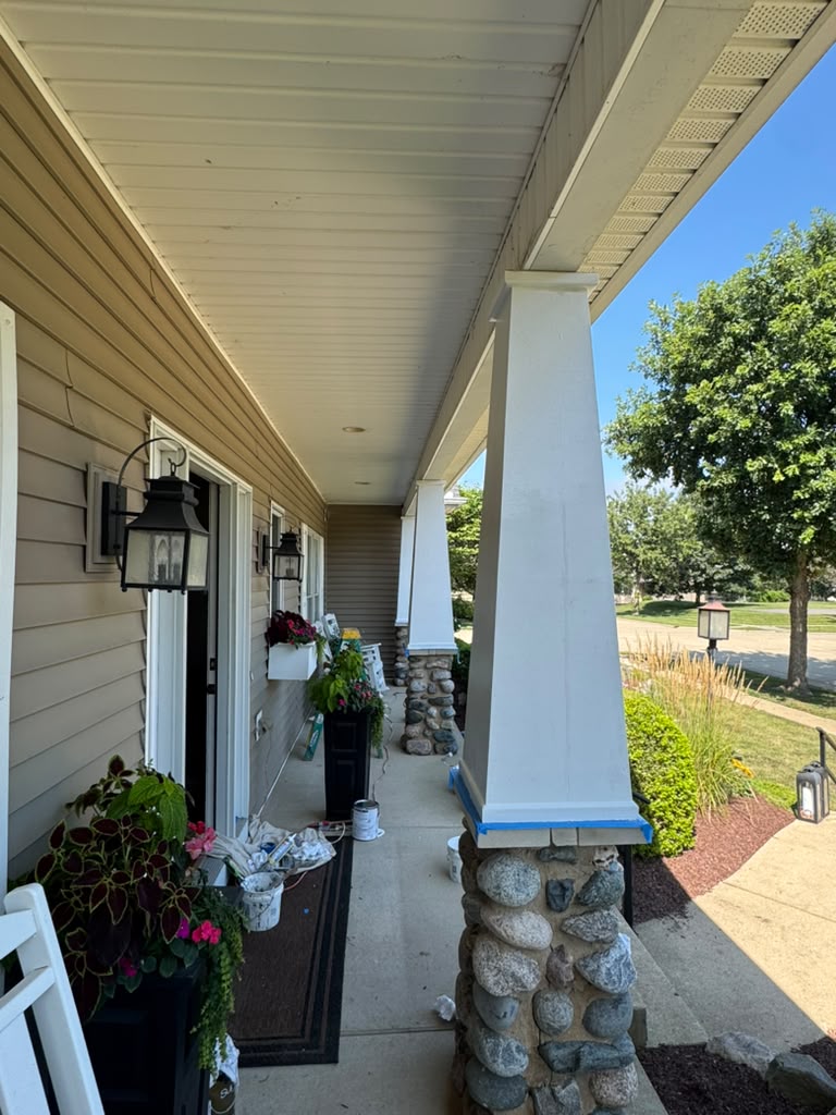 Porch column being painted with masking tape prep
