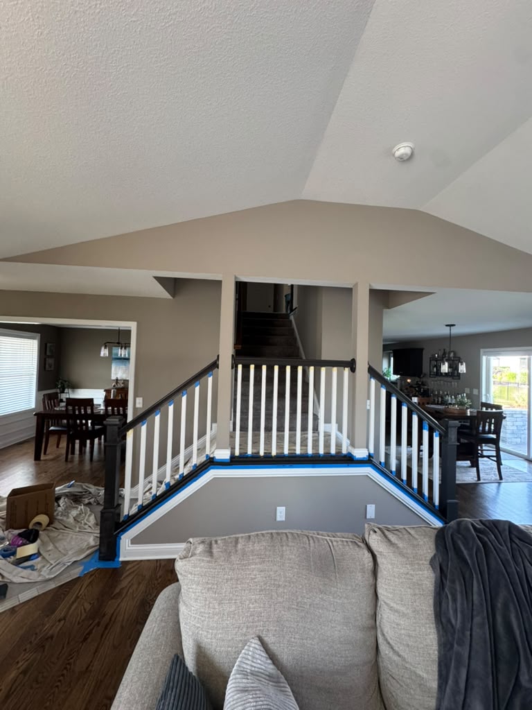 Staircase railing taped for painting